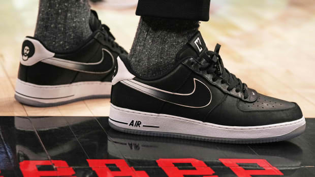 View of black and white Nike Air Force shoes.